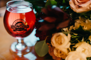 Branded glass of beer near floral table centerpiece